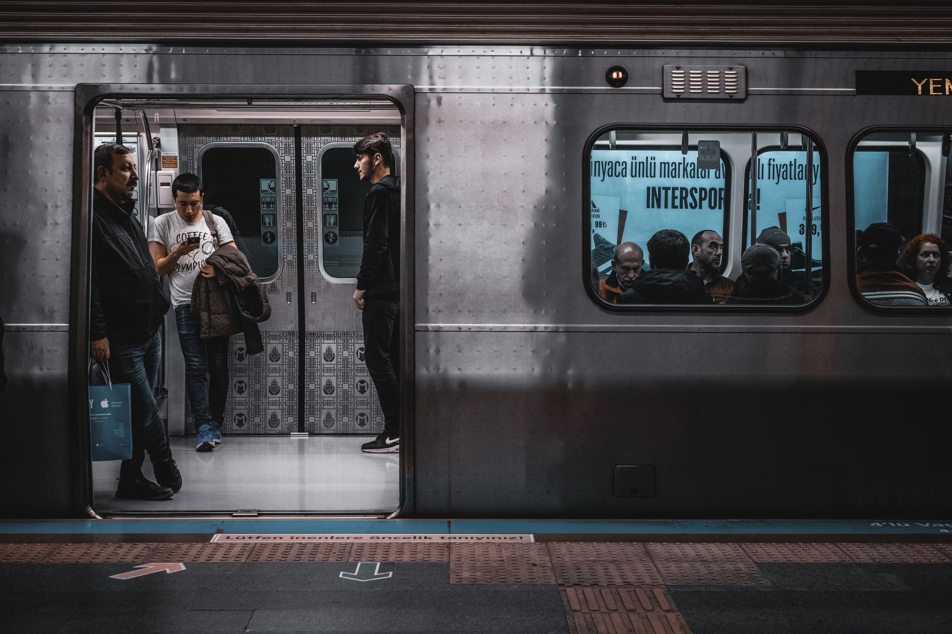 Istanbul subway scene showing passengers, emphasizing local travel costs.