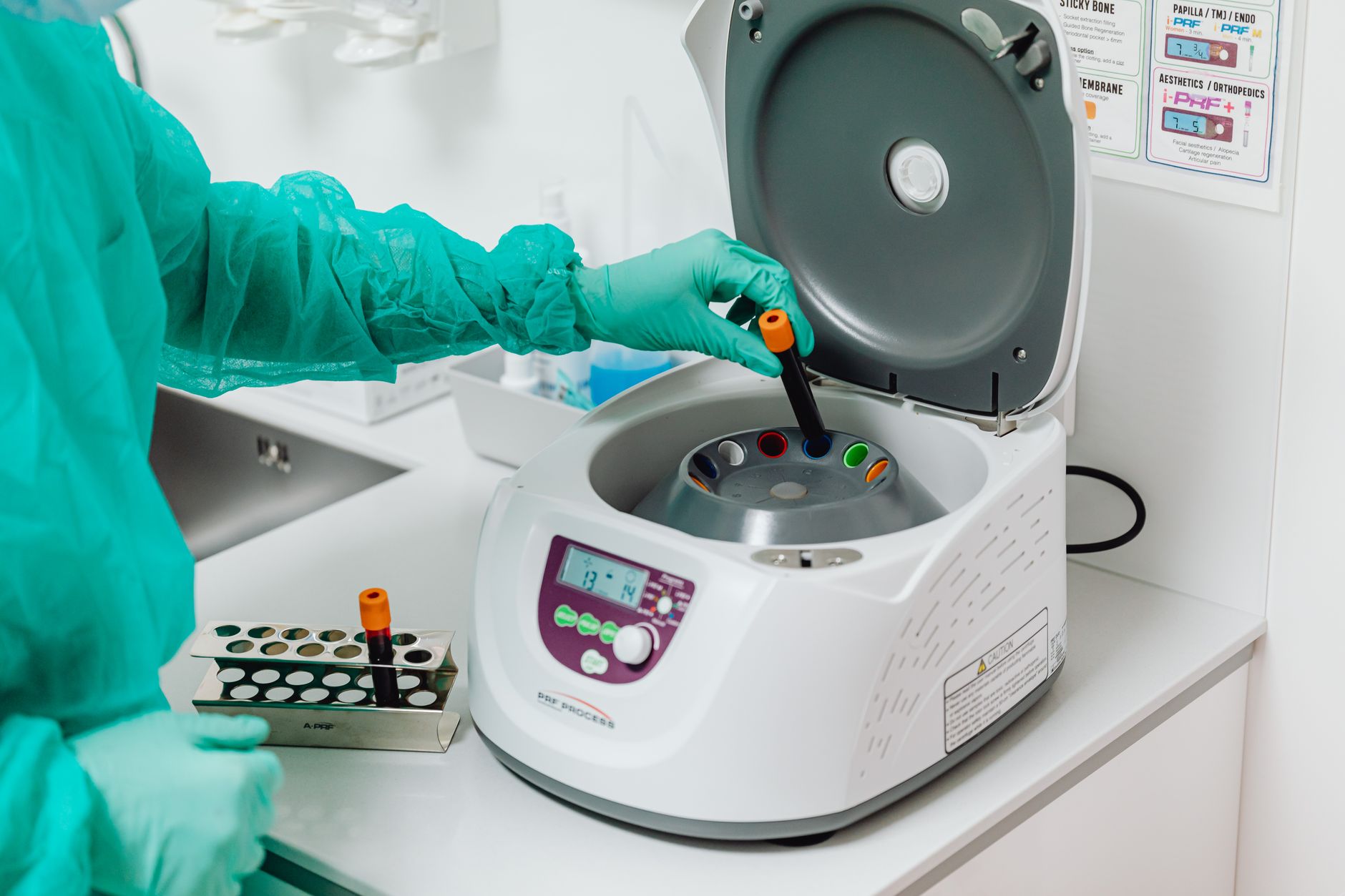 A lab technician uses a centrifuge for biomarker testing in a Turkish hospital.