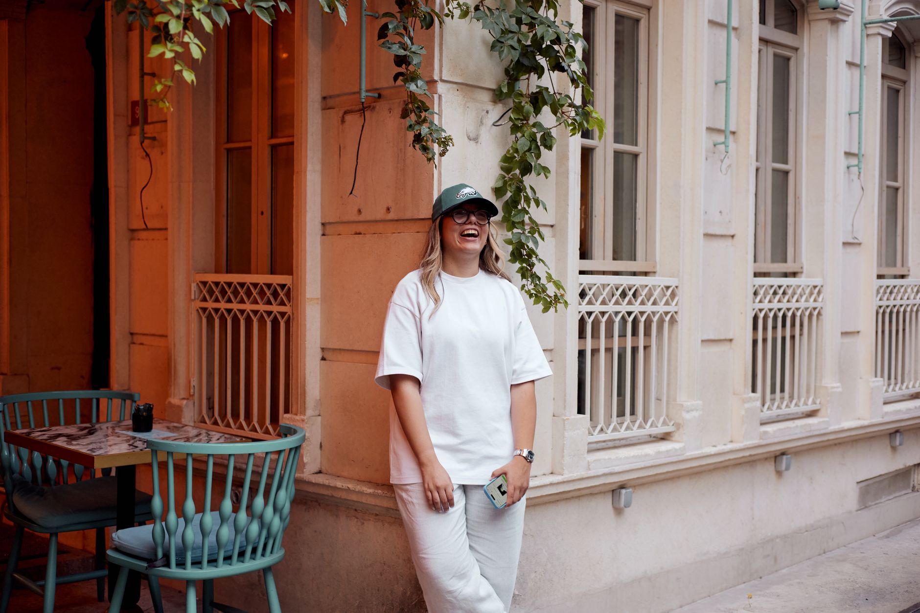 A smiling woman in a white outfit stands in Istanbul, symbolizing recovery.