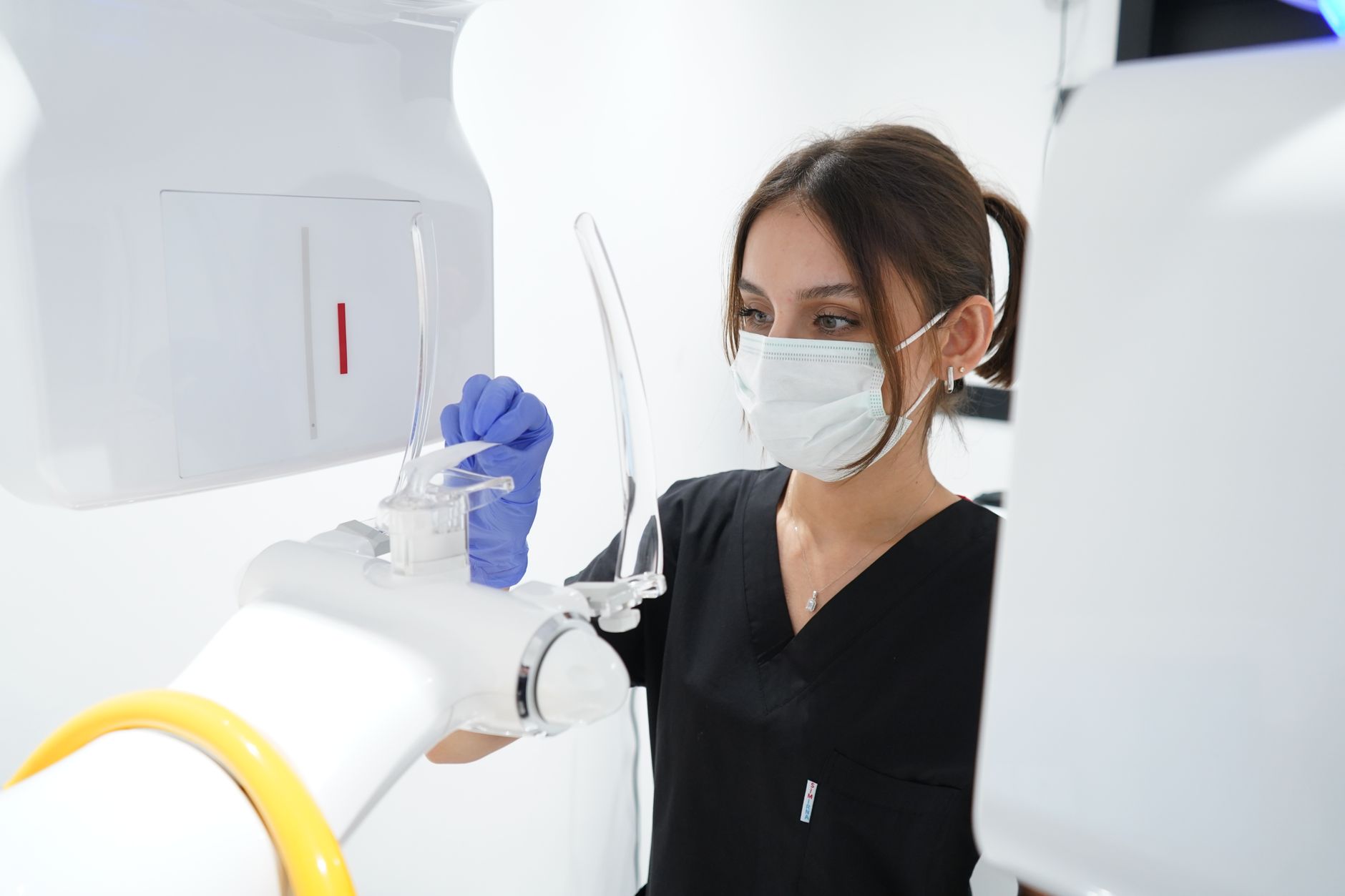 Medical professional preparing ultrasound equipment in a bright clinic in Türkiye.
