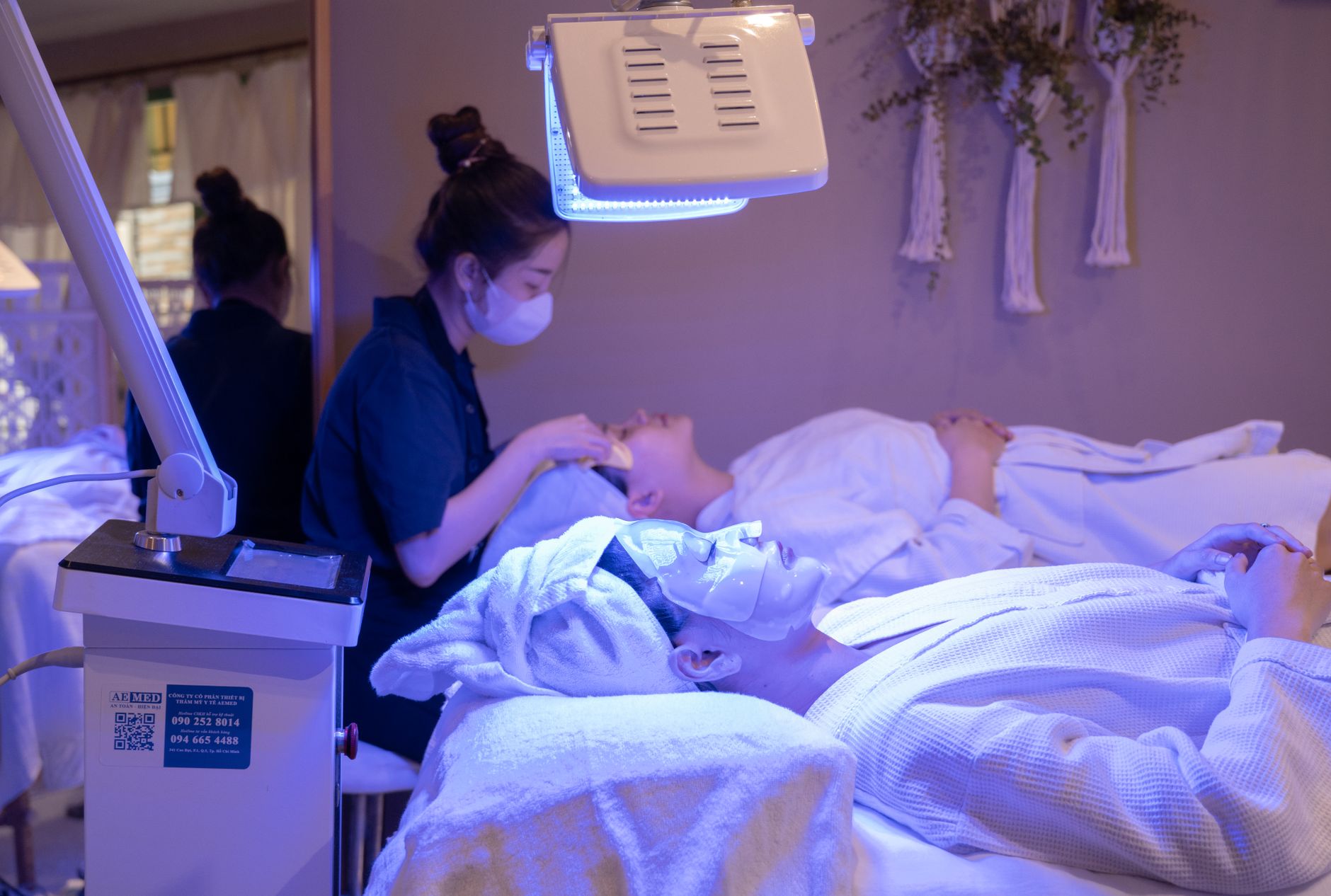 Two patients receiving facial treatments in a calming spa environment.