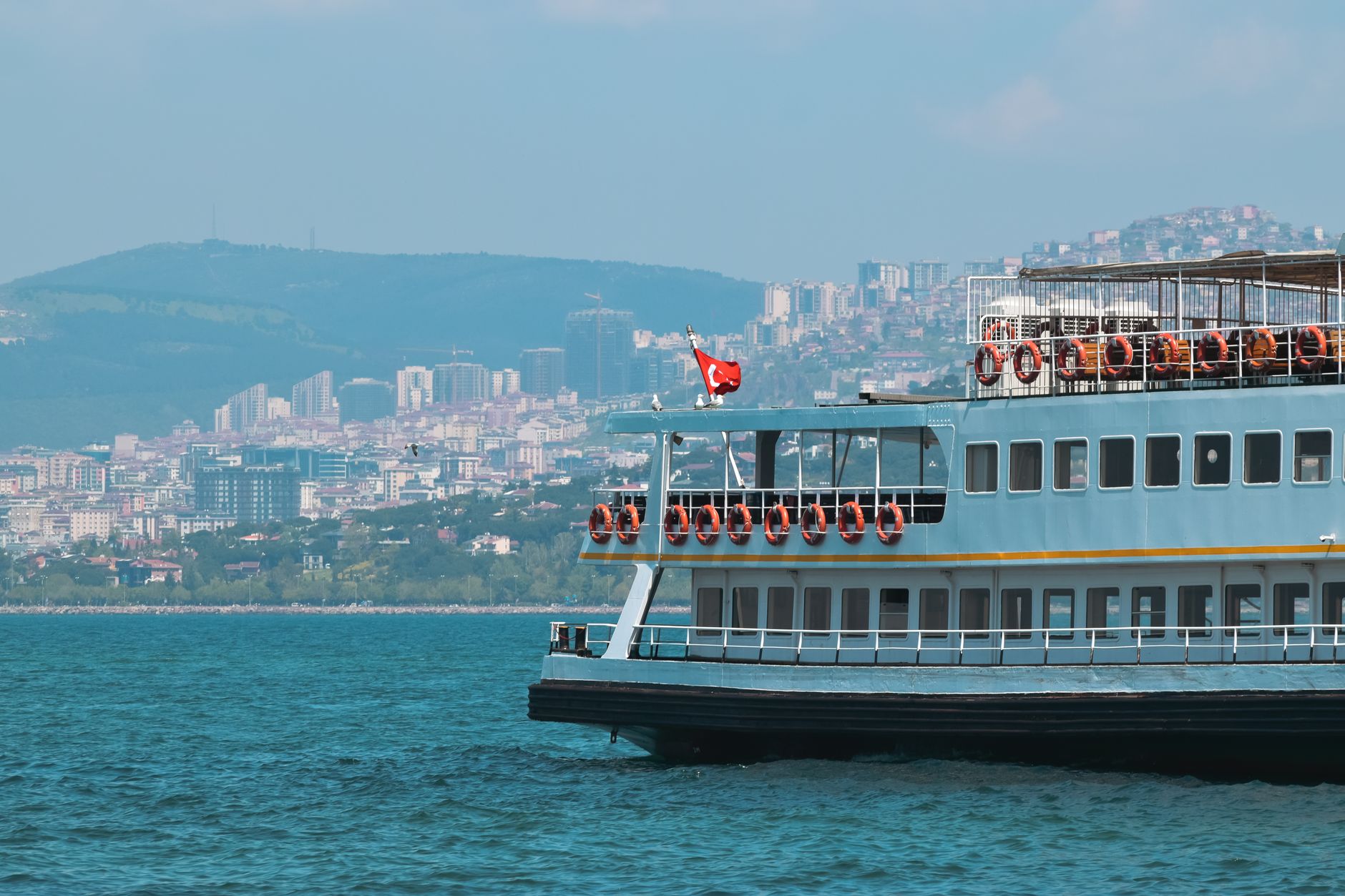 A ferry on the Bosphorus with Istanbul's skyline in the background, creating a tranquil atmosphere.