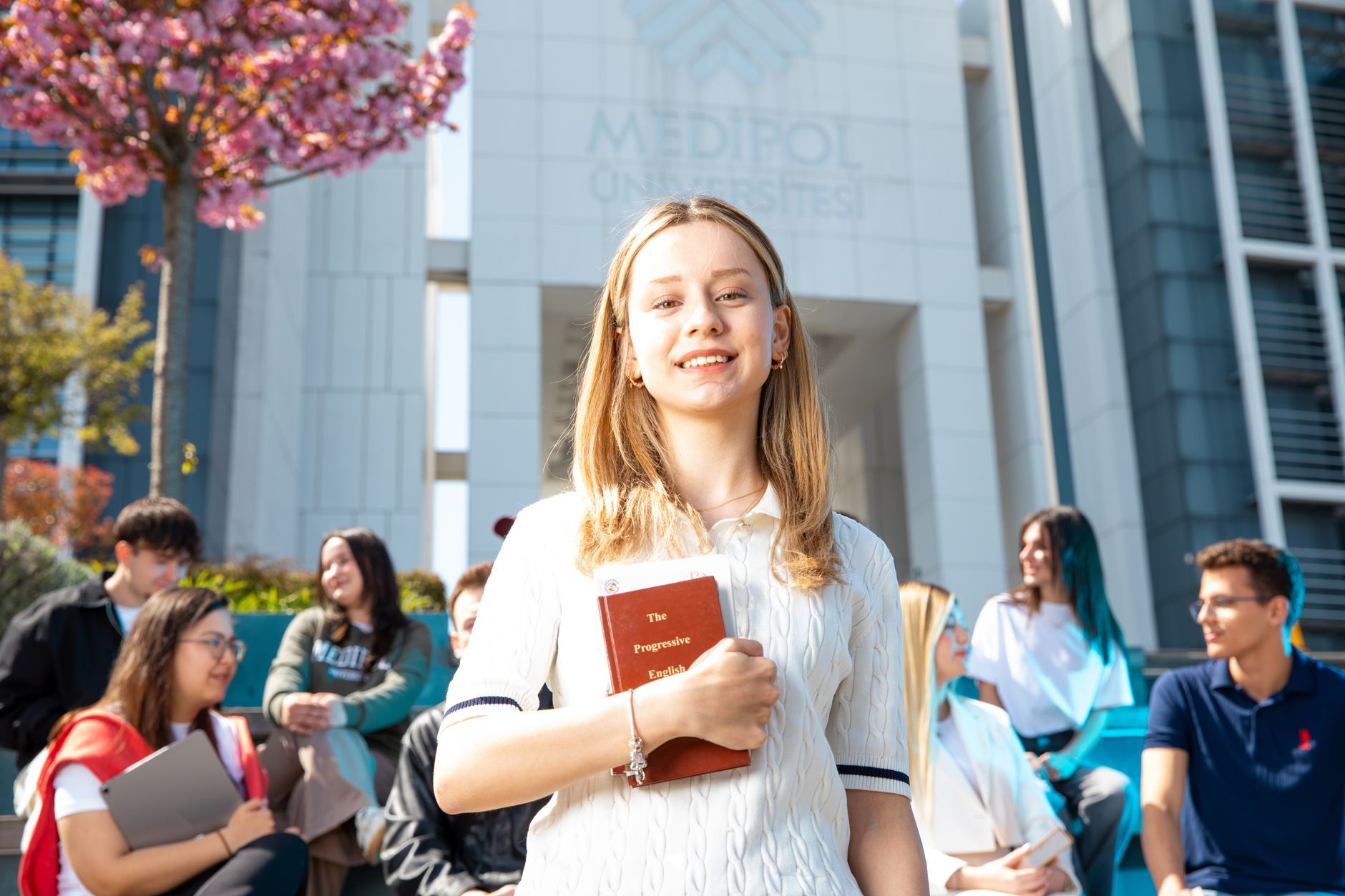 Students at Medipol University, Turkey, engage in academic discussions outdoors.