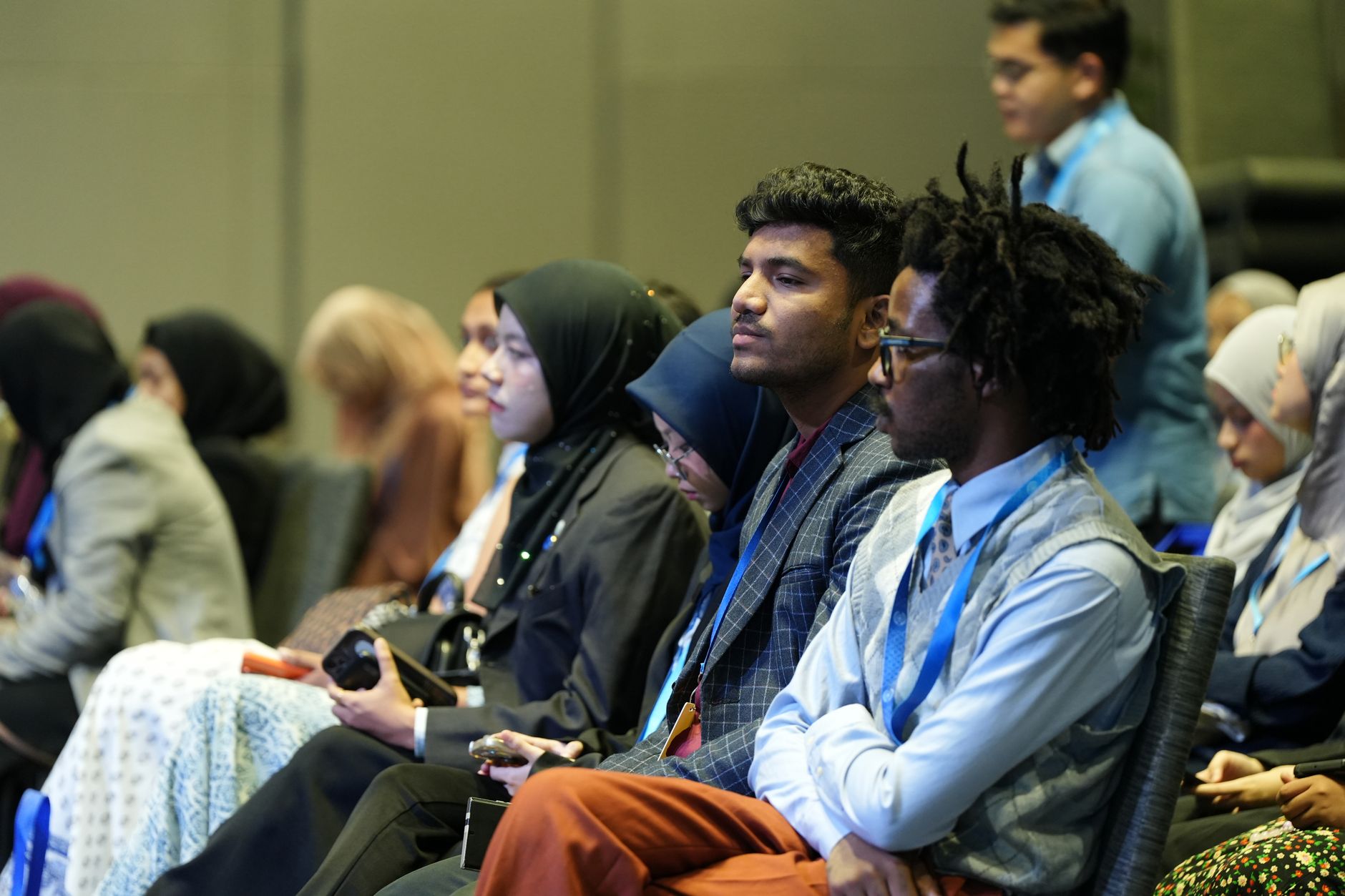 A diverse group of healthcare professionals seated at a conference in Istanbul.